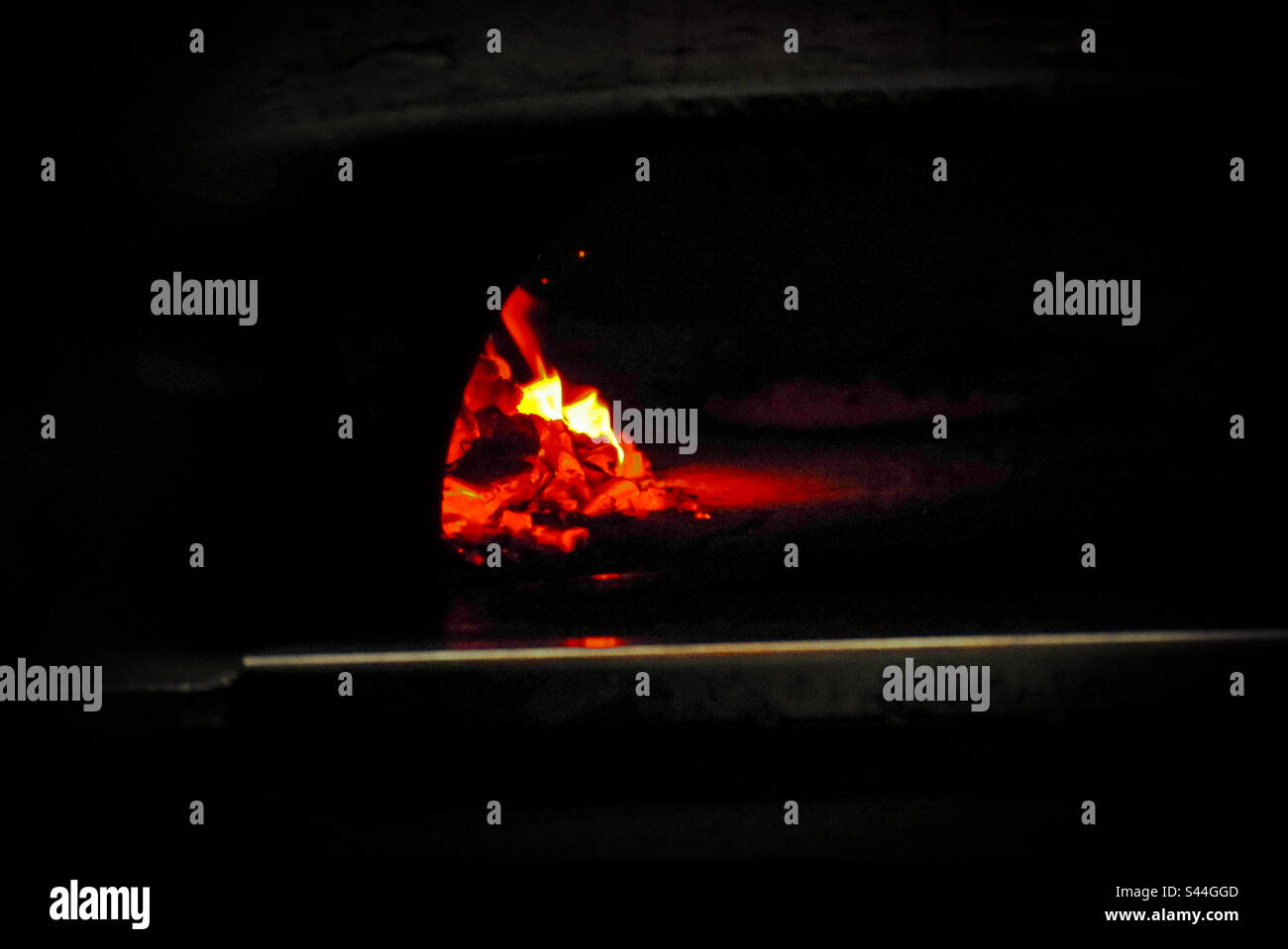 Fire in wood burning pizza oven - Smartphone Captured Stock Image