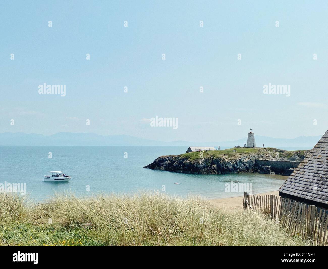 Pilot’s cove on Llandwyn island, Newborough, Anglesey, North Wales, on a sunny, warm, May Day 2023 with view across to the mainland of Llyn Peninsula - Smartphone Captured Stock Image