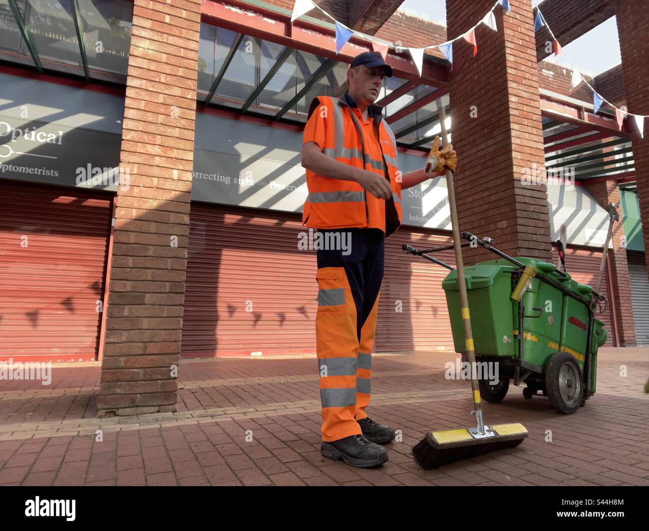 Serco street cleaner in hi vis uniform Stock Photo Alamy