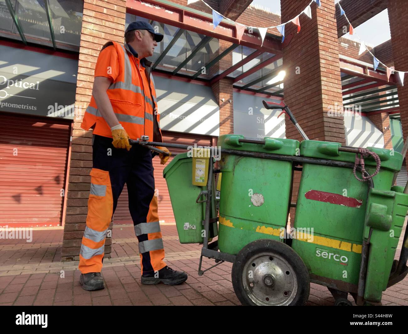 Serco street cleaner in hi vis uniform Stock Photo Alamy
