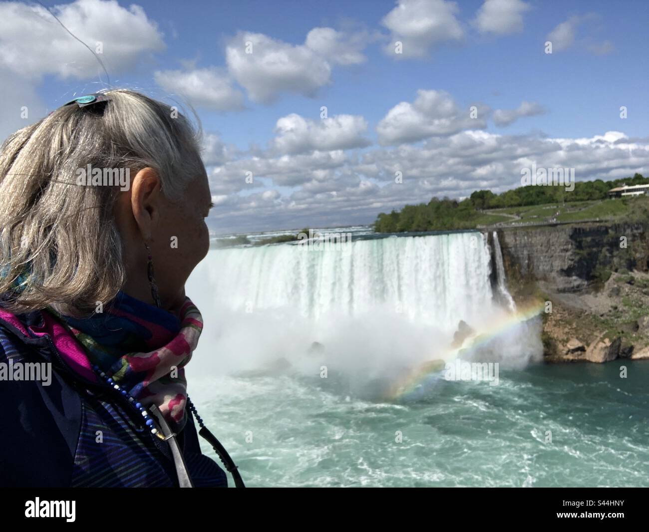 A woman looking at the waterfalls in Niagara Falls, Ontario, Canada. - Smartphone Captured Stock Image