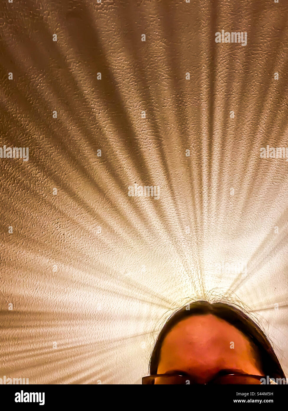 Light reflections above woman’s head - Smartphone Captured Stock Image