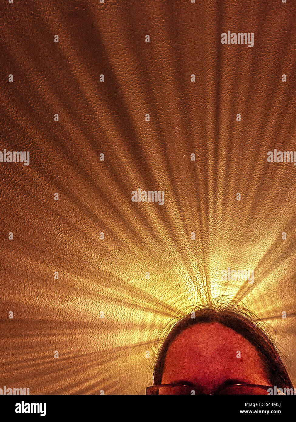 Light shines above woman’s head - Smartphone Captured Stock Image