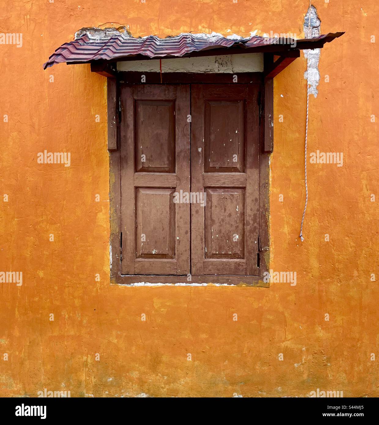 Wooden shutters with metal awning Stock Photo