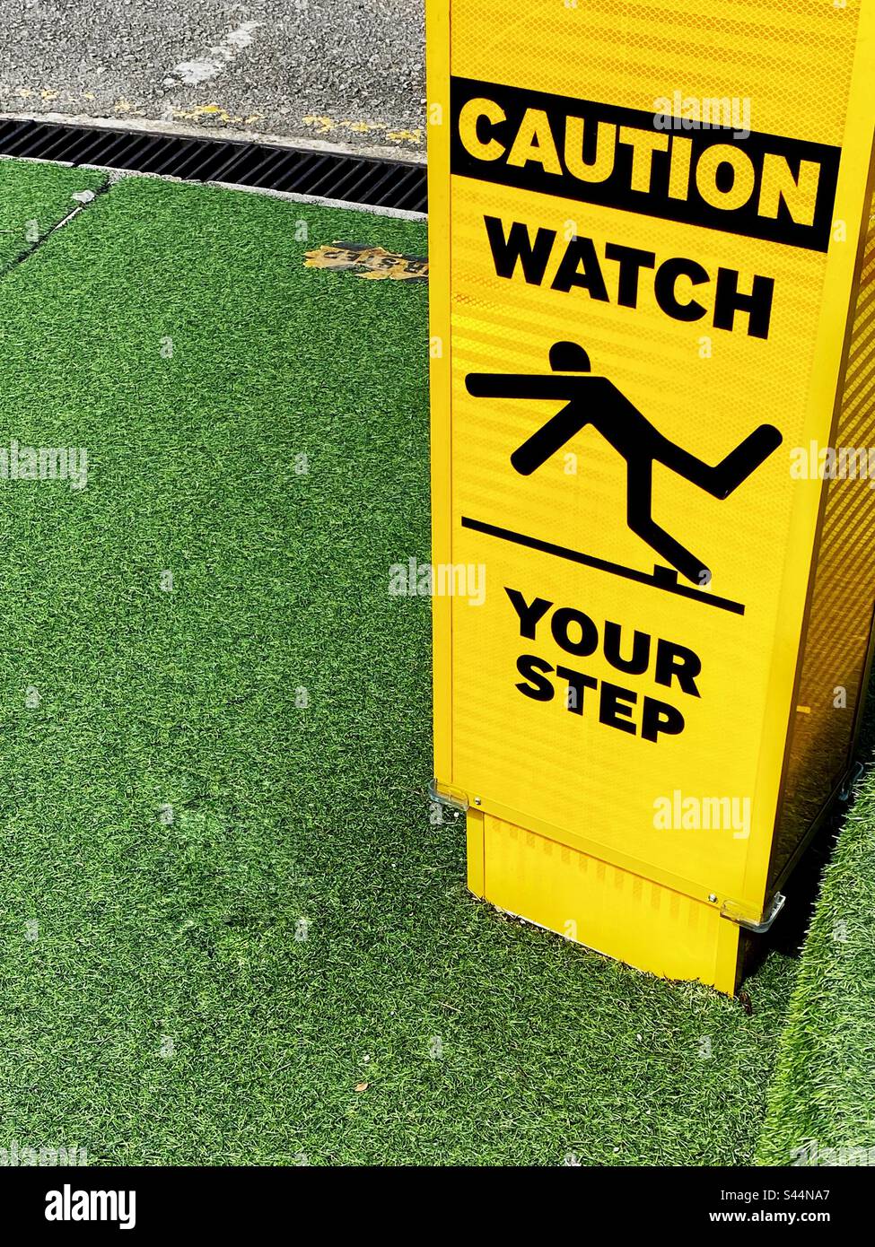 Yellow caution sign, watch your step. Stock Photo