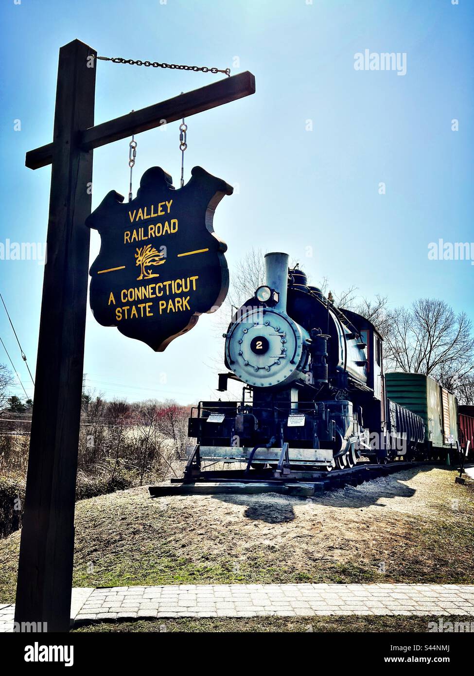 Sign for Valley Railroad, A Connecticut State Park, with old-fashioned Essex Steam Train.  Essex, Connecticut, USA. - Smartphone Captured Stock Image