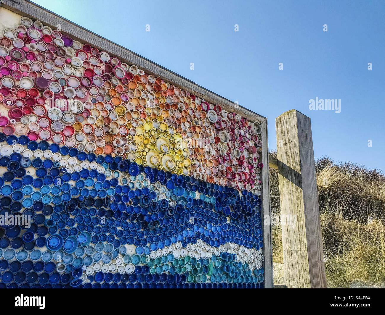 Artwork canva made with plastic bottle caps - Smartphone Captured Stock Image
