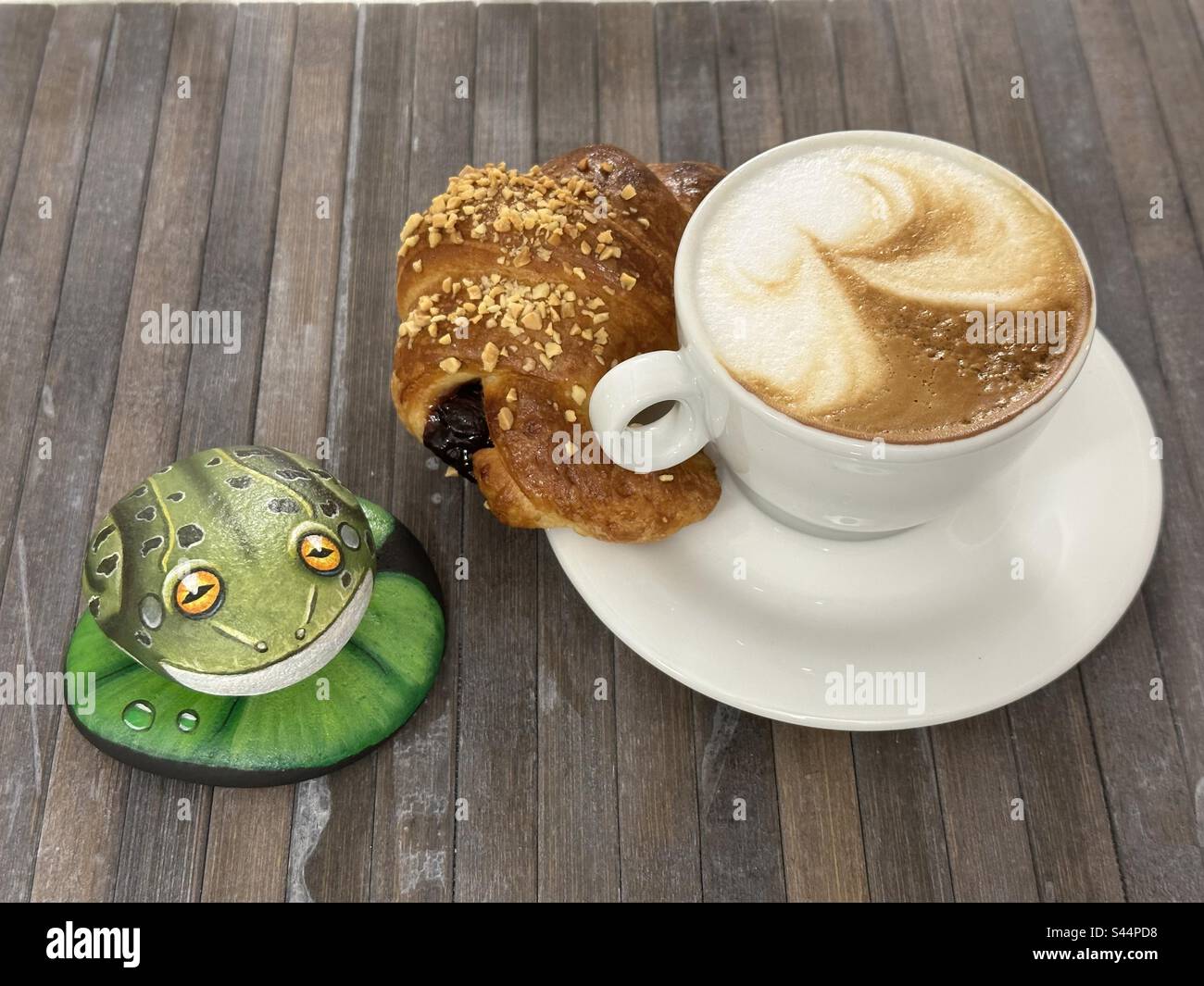 Italian breakfast with a hand painted stone frog Stock Photo