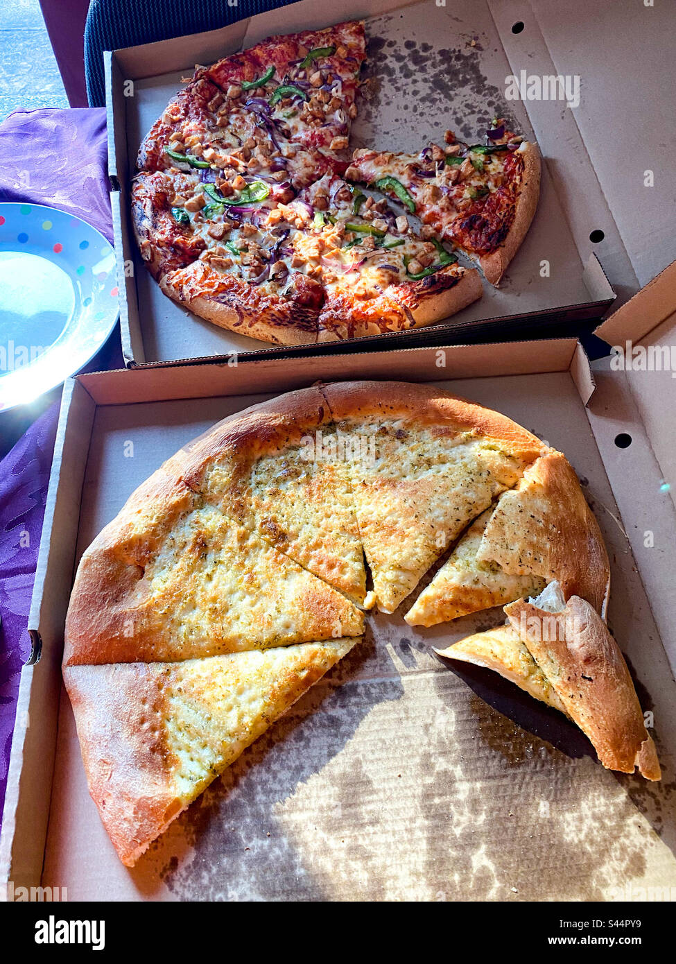 Takeaway pizza and garlic bread in cardboard boxes. - Smartphone Captured Stock Image