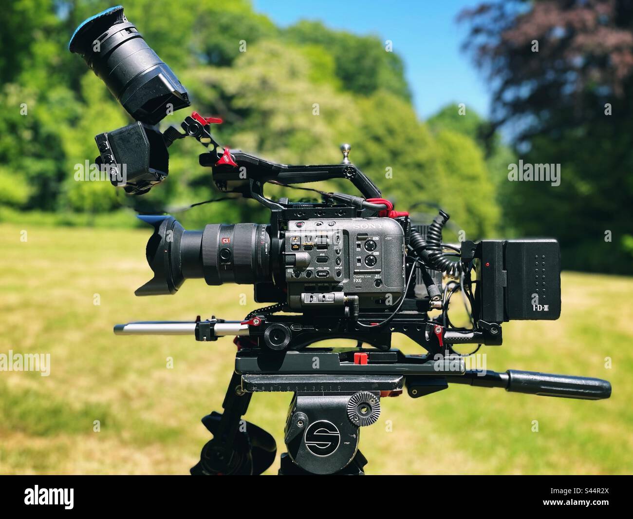 Sony FX-6 film camera on a tripod in a park - Smartphone Captured Stock Image