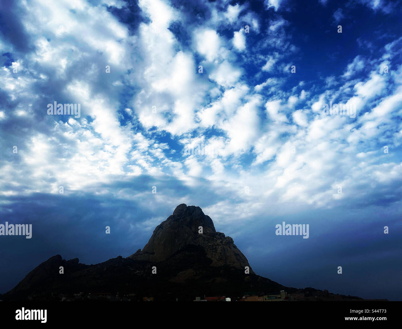 Clouds cover the Peña de Bernal monolite mountain in Queretaro, Mexico - Smartphone Captured Stock Image