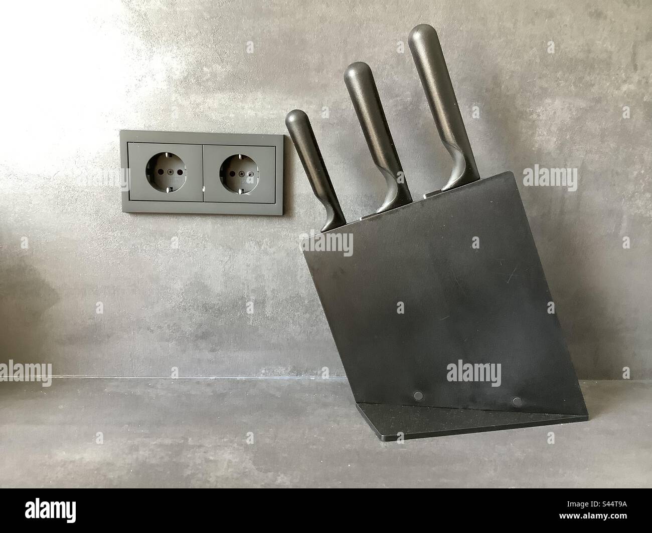 Black sockets and knife block in kitchen Stock Photo Alamy