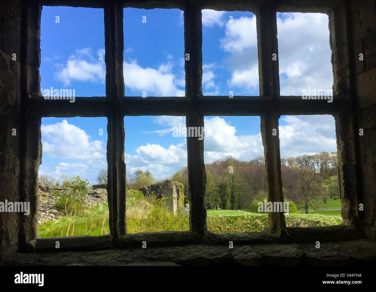 Looking out a window in a ruined building, out across an English country landscape. Stock Photo