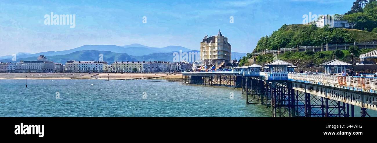 Panoramic view from Llandudno pier in North Wales looking towards the Grand Hotel the Promenade and the Snowdonia mountains in the background - Smartphone Captured Stock Image