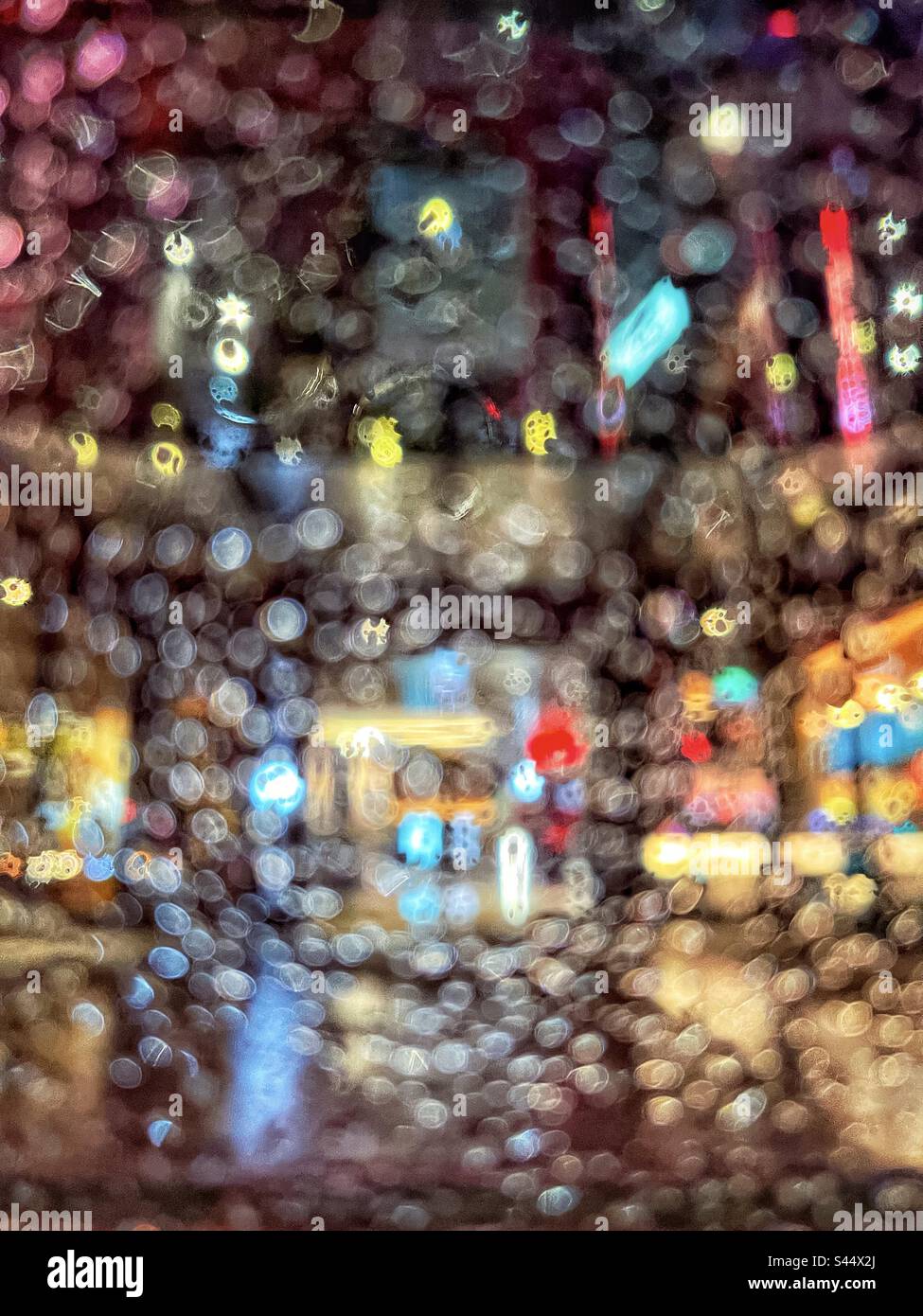 Abstract pattern of raindrop blur bokeh and city night light. Full frame. Backgrounds. Multicolored. Defocused. - Smartphone Captured Stock Image