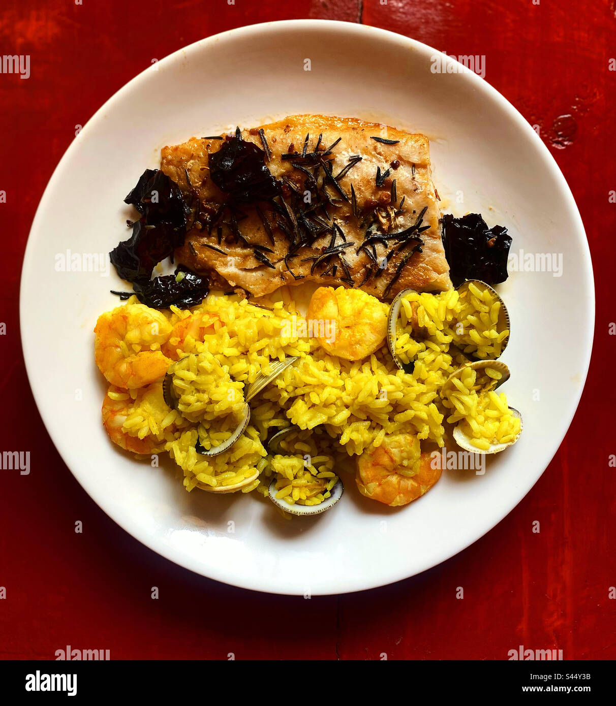 Fish with rosemary and pasilla chilli and yellow rice with clams and shrimp in Quereraro, Mexico - Smartphone Captured Stock Image