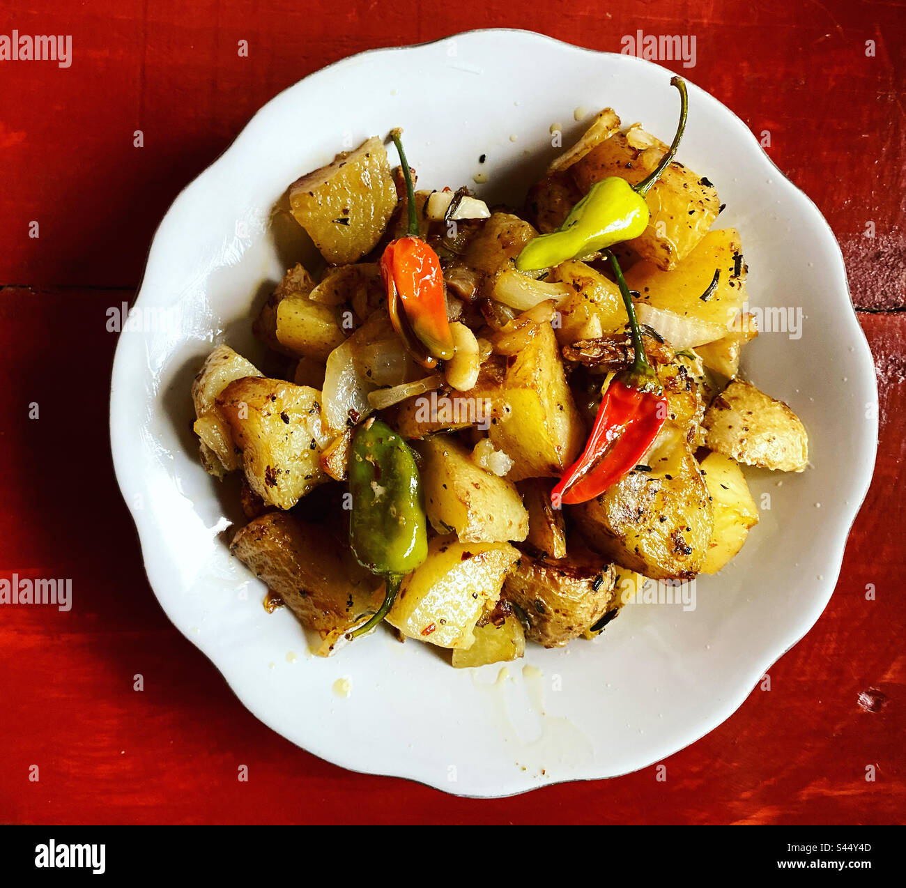 Fried potatoes with green and red chilli peppers in a restaurant in Queretaro, Mexico - Smartphone Captured Stock Image