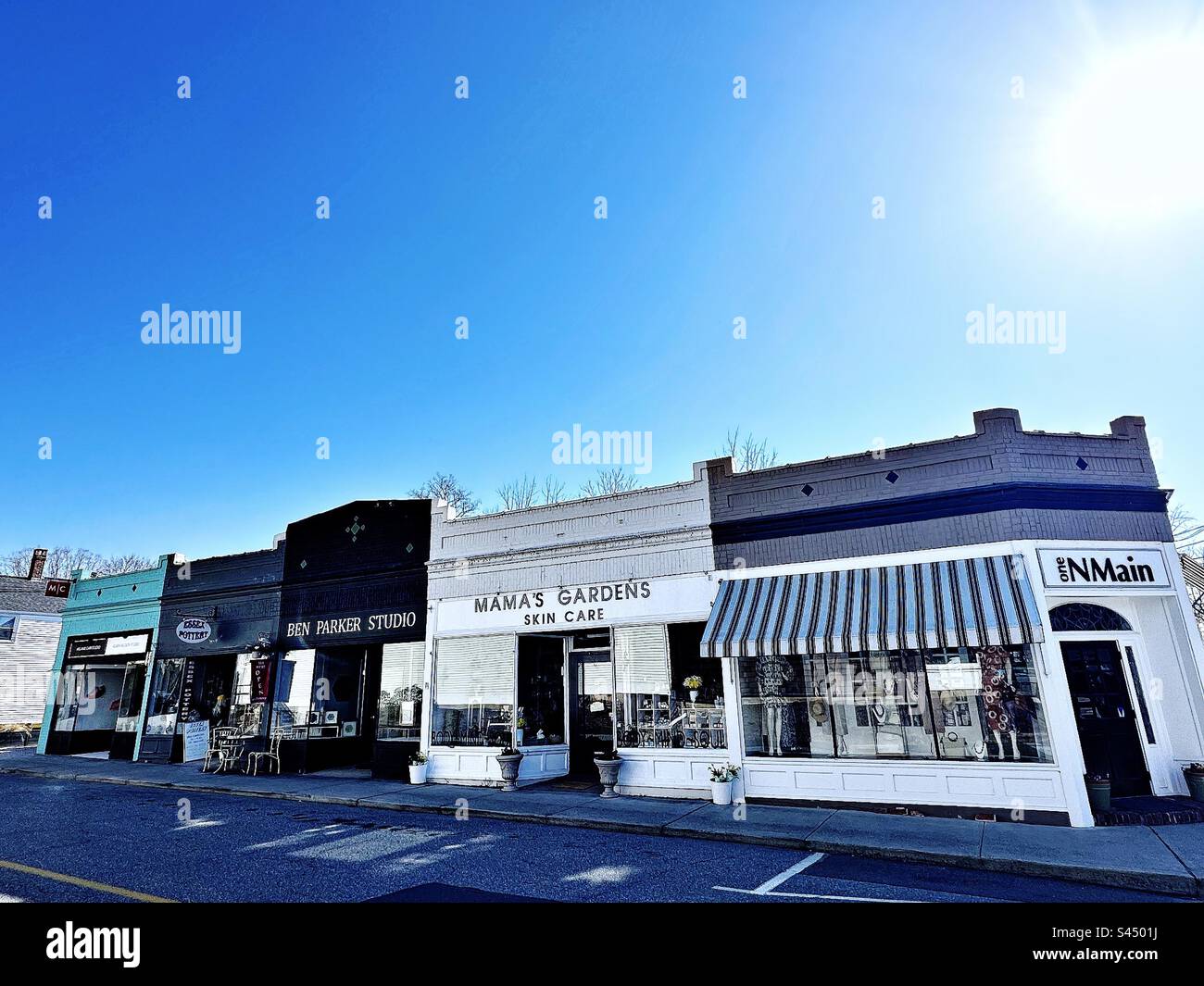 Street with stores in Essex, Connecticut, USA. Sun rays in top right corner shining down. - Smartphone Captured Stock Image Street with stores in Essex, Connecticut, USA. Sun rays in top right corner shining down. - Smartphone Captured Stock Image