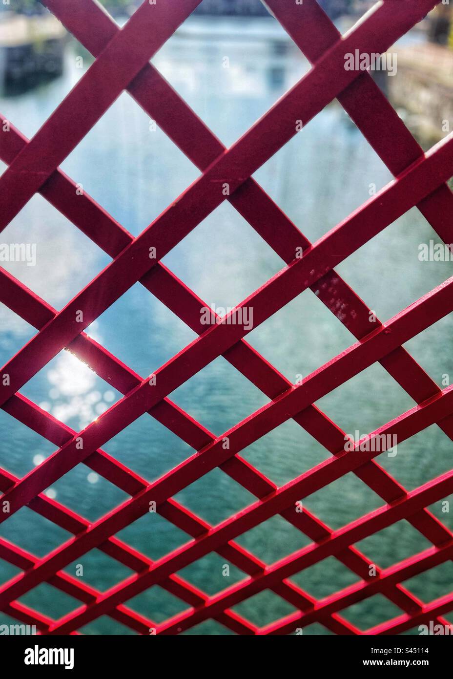 Looking through the metalwork of the bridge - water reflection - Smartphone Captured Stock Image