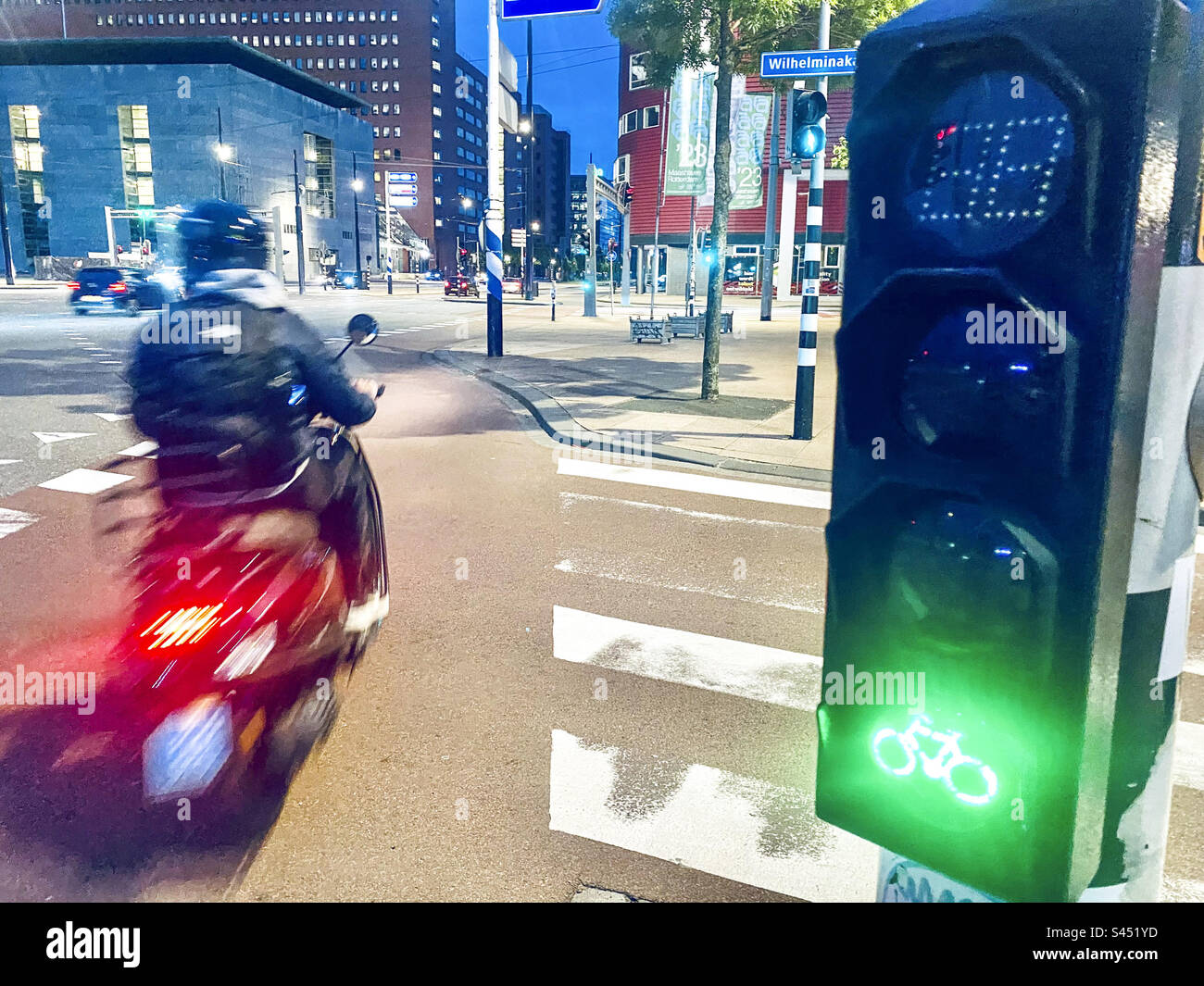 A scooter goes through a green light in Rotterdam - Smartphone Captured Stock Image