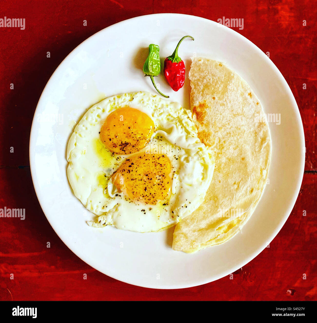 Two fried eggs, a cheese quesadilla and a chile green and red for breakfast in Queretaro, Mexico Stock Photo