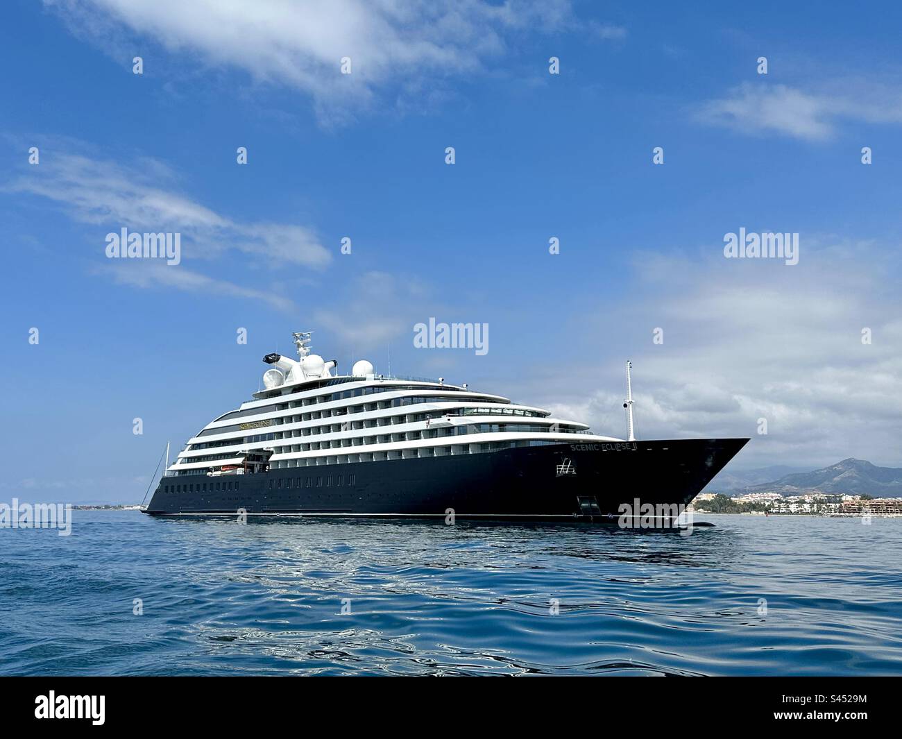 Scenic Eclipse 2, a luxury ocean cruising yacht moored outside the harbour at Puerto Banus in Spain - Smartphone Captured Stock Image