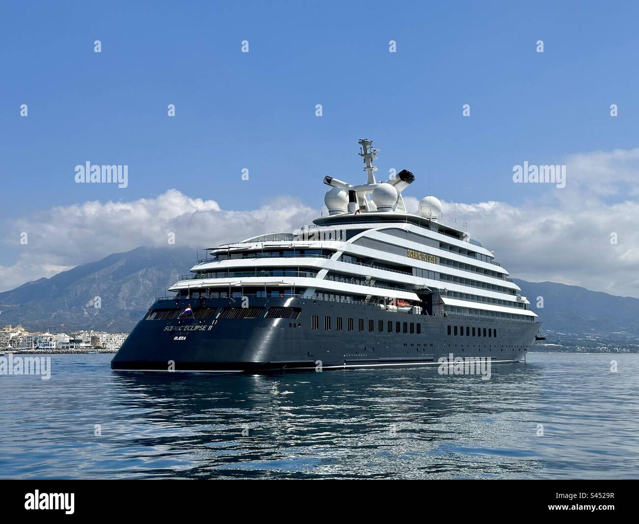 Scenic Eclipse 2, a luxury ocean cruising yacht moored outside the harbour at Puerto Banus in Spain Stock Photo