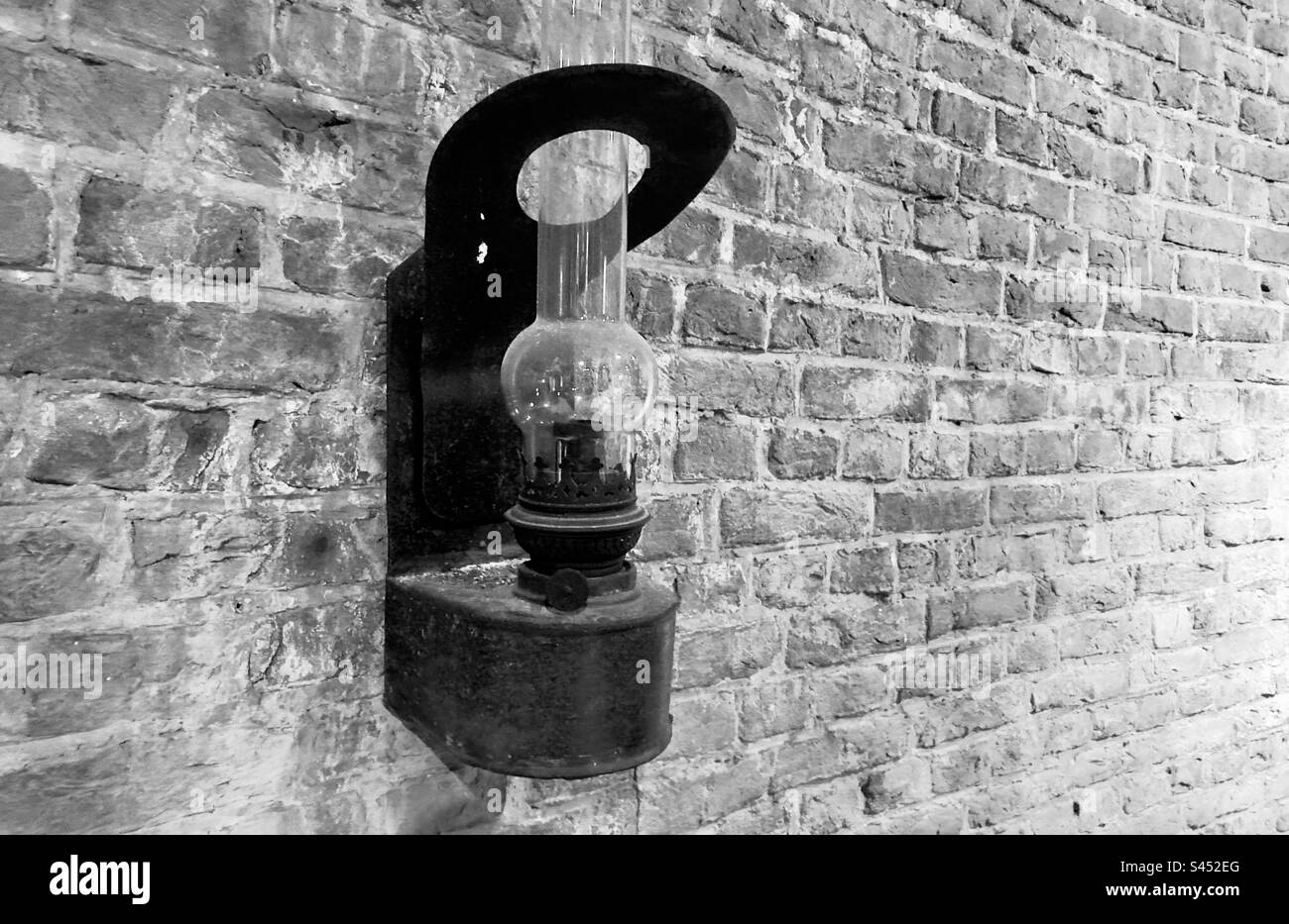 An old oil lamp faced to a wall in the Windmill museum in Leiden in the Netherlands Stock Photo