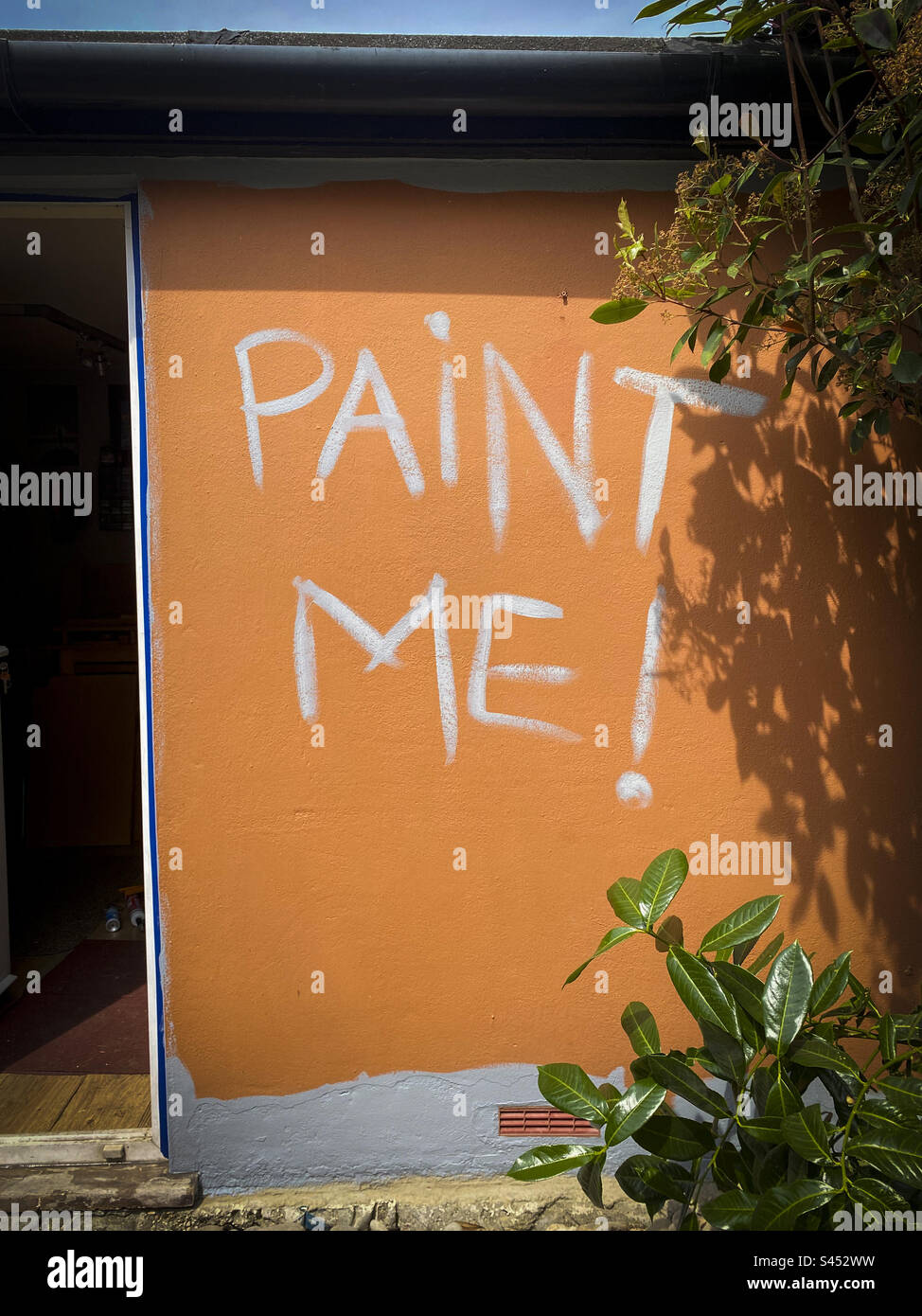 Hand painted sign on a wall says Paint Me - Smartphone Captured Stock Image