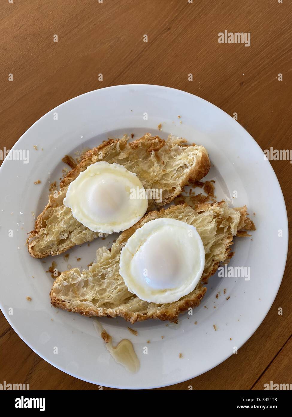Poached eggs on a croissant Stock Photo
