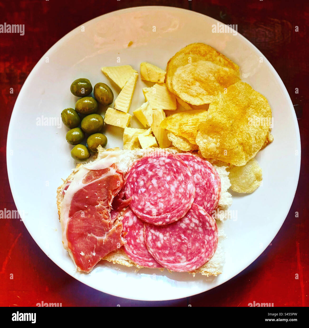 Olives, cheese, fried potato chips, Spanish salami and jamon serrano