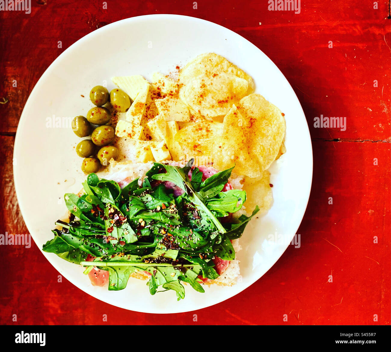 Green olives, cheese, fried potato chips and arugula salad in Queretaro