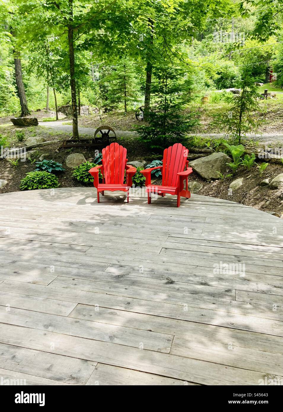 Two red Muskoka chairs in a beautiful setting Stock Photo Alamy