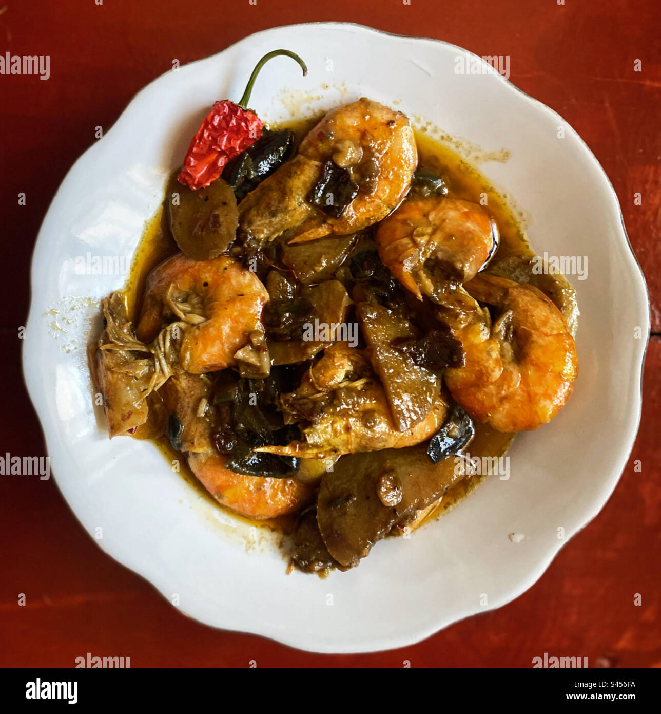 Shrimp with potatoes and red hot chilli peppers with garlic in Queretaro, Mexico - Smartphone Captured Stock Image