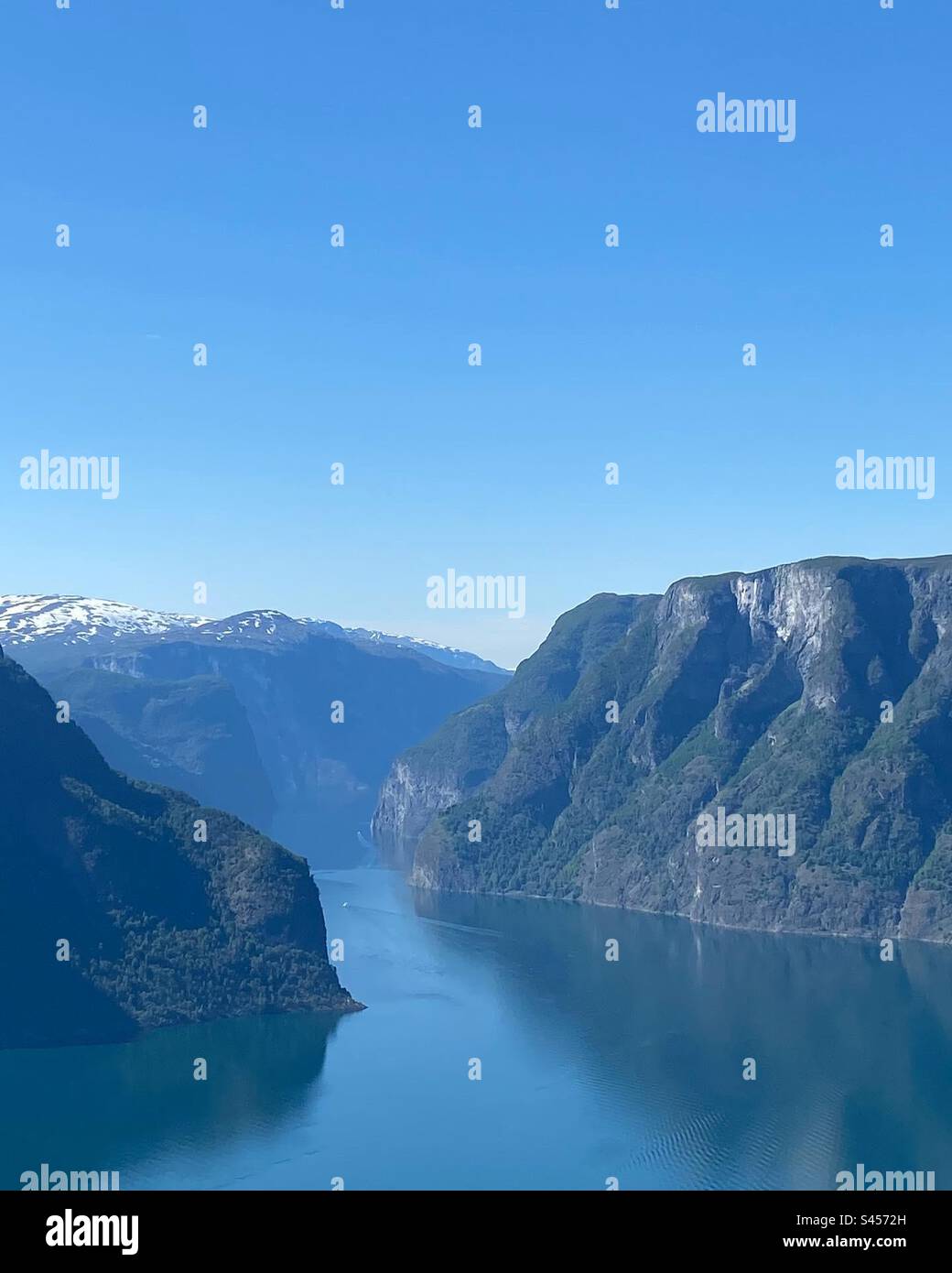 The view from fjords in Flåm village, Sweden is unreal! You can see the river winding through the valley, like a shimmering ribbon. Nature's artwork at its finest. Stock Photo