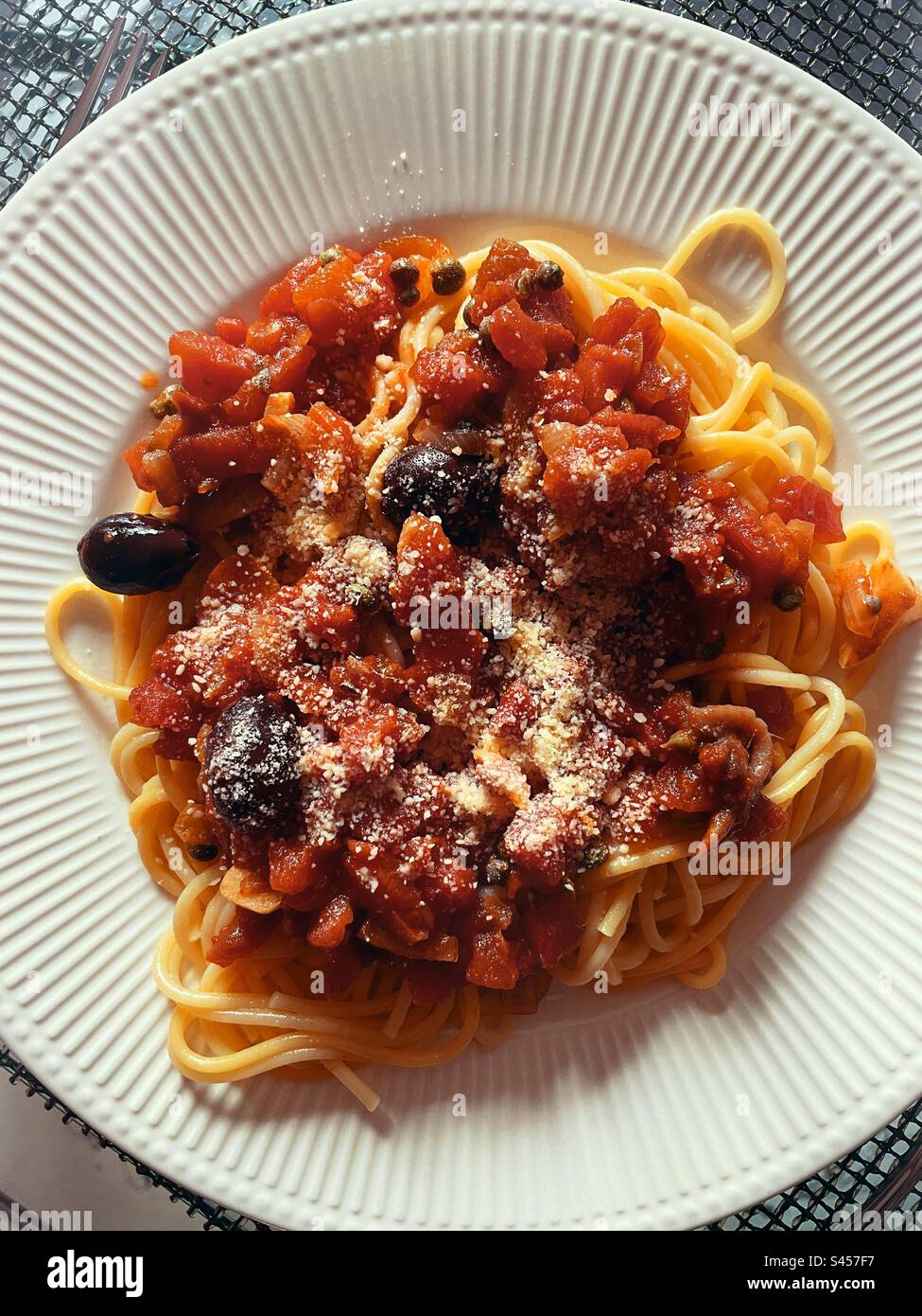 Flat lay of a main main course pasta dish of Puttanesca on spaghetti