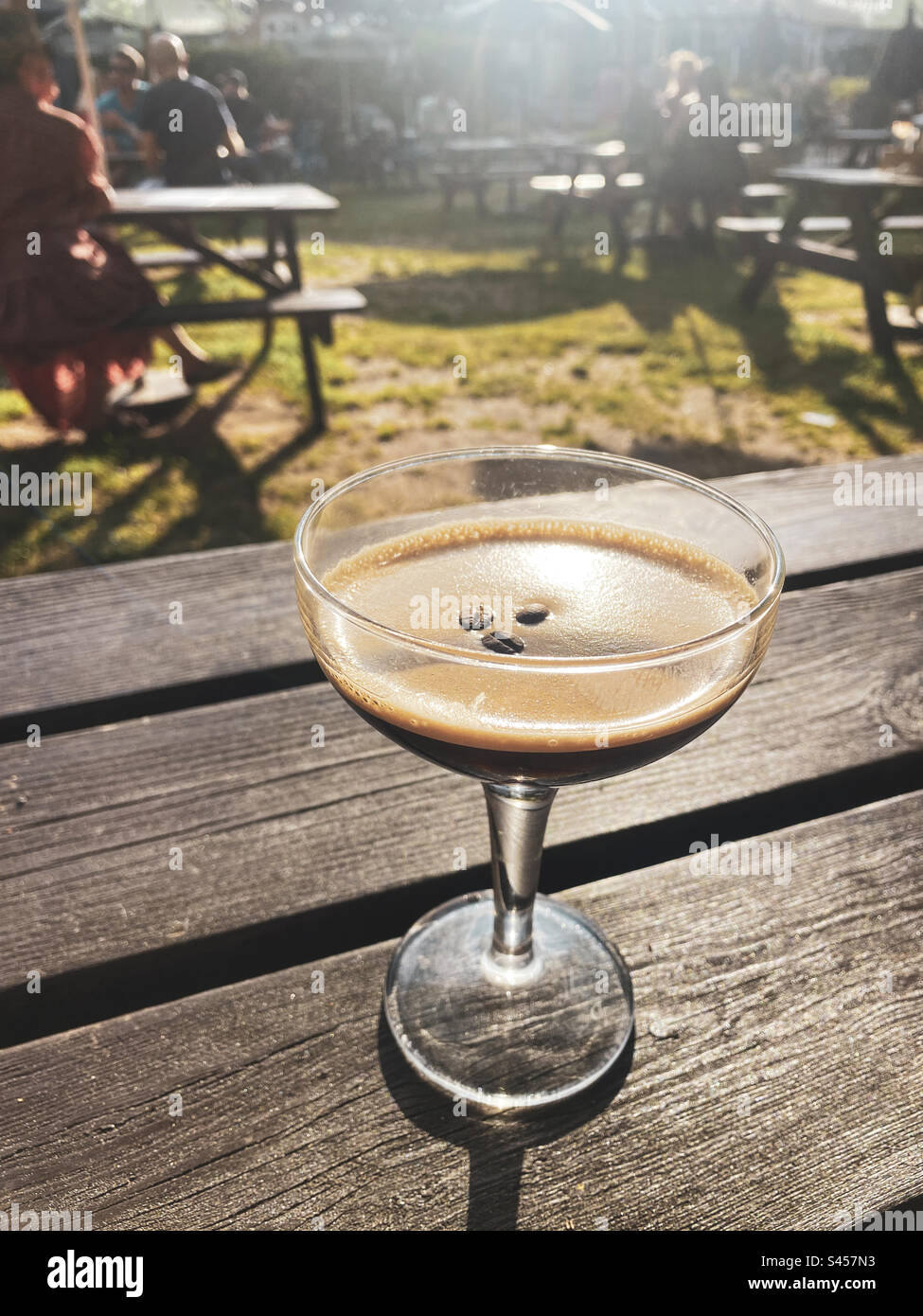 Espresso Martini in a glass at a beer garden on a hot day in London - Smartphone Captured Stock Image