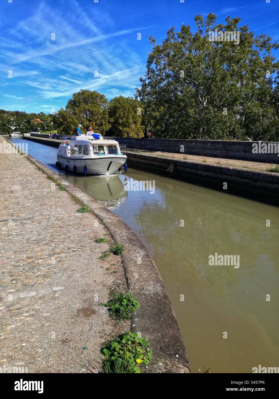 Canal du Midi. Boat passing on the bridge canal in Beziers. Occitanie, France Stock Photo