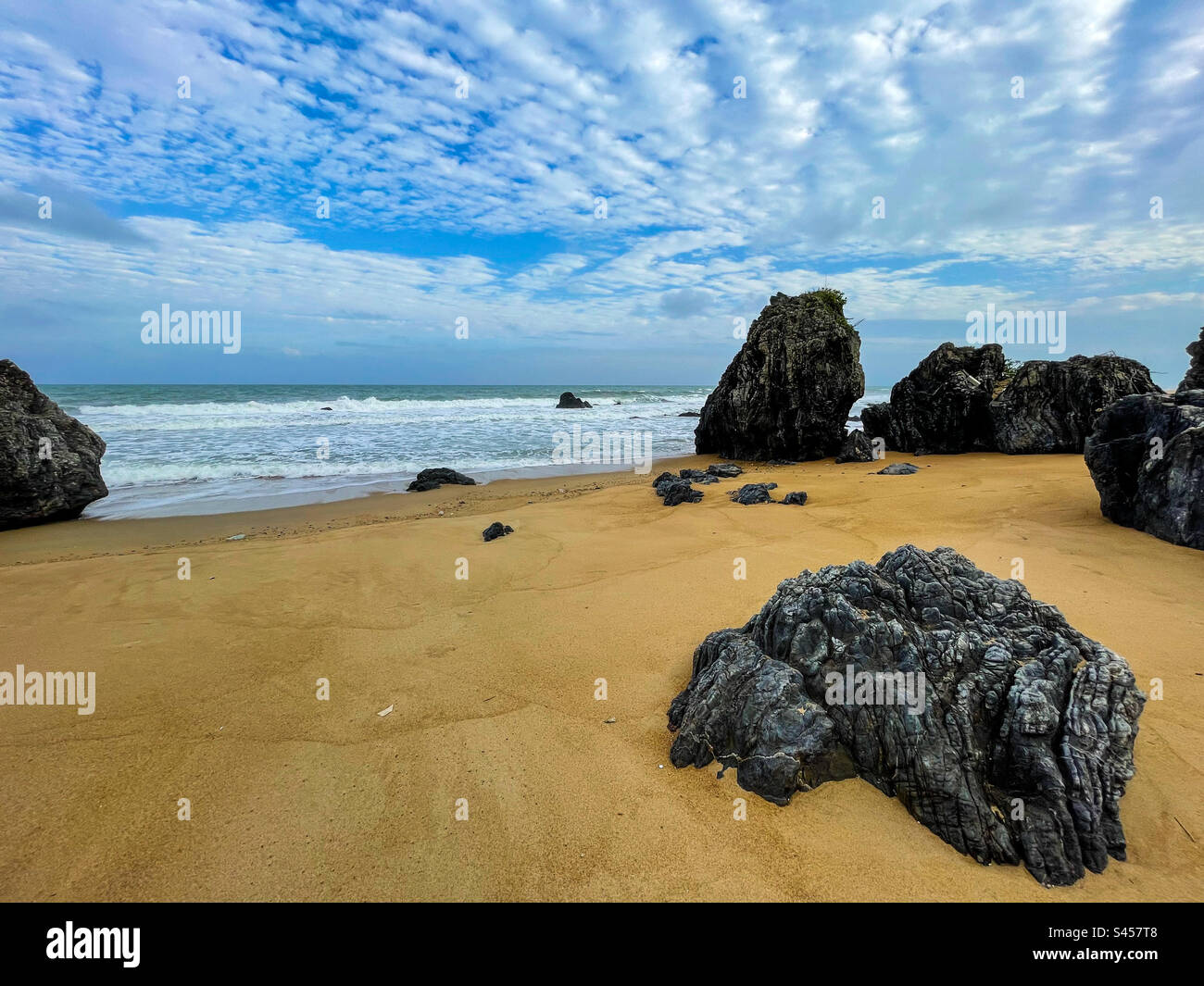 Movement in the sky on a rocky beach - Smartphone Captured Stock Image