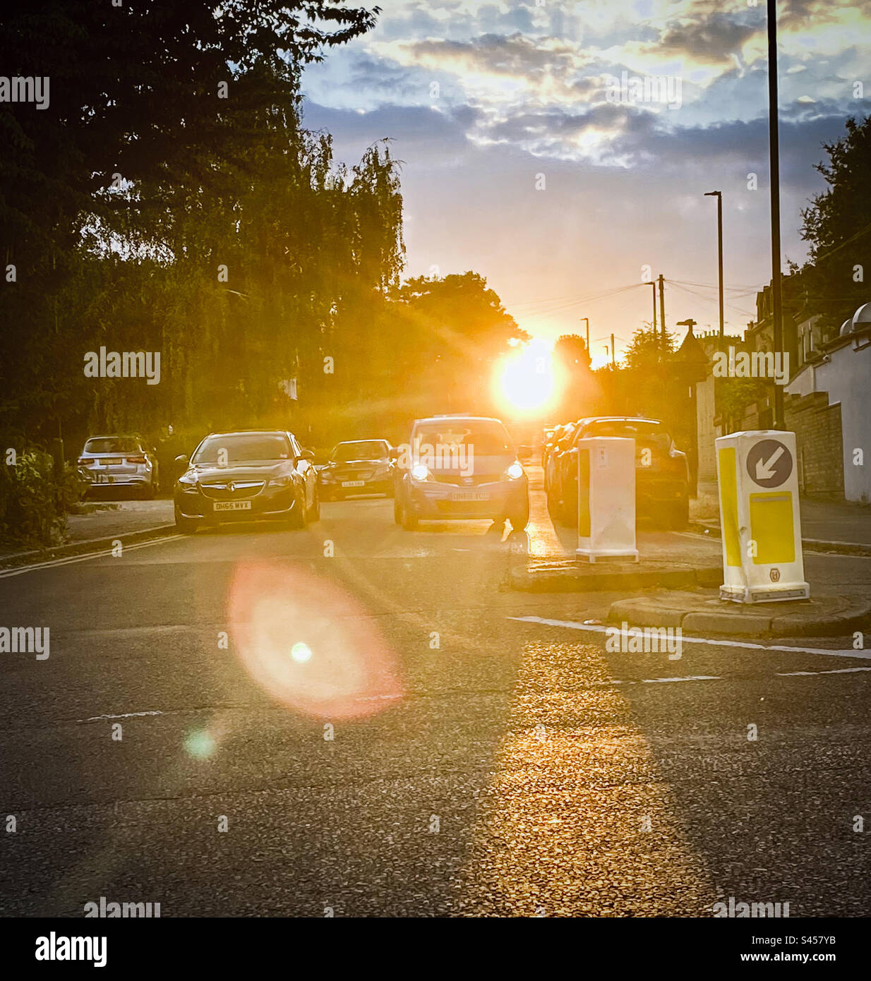 A bright sun sets at the end of a London street - Smartphone Captured Stock Image