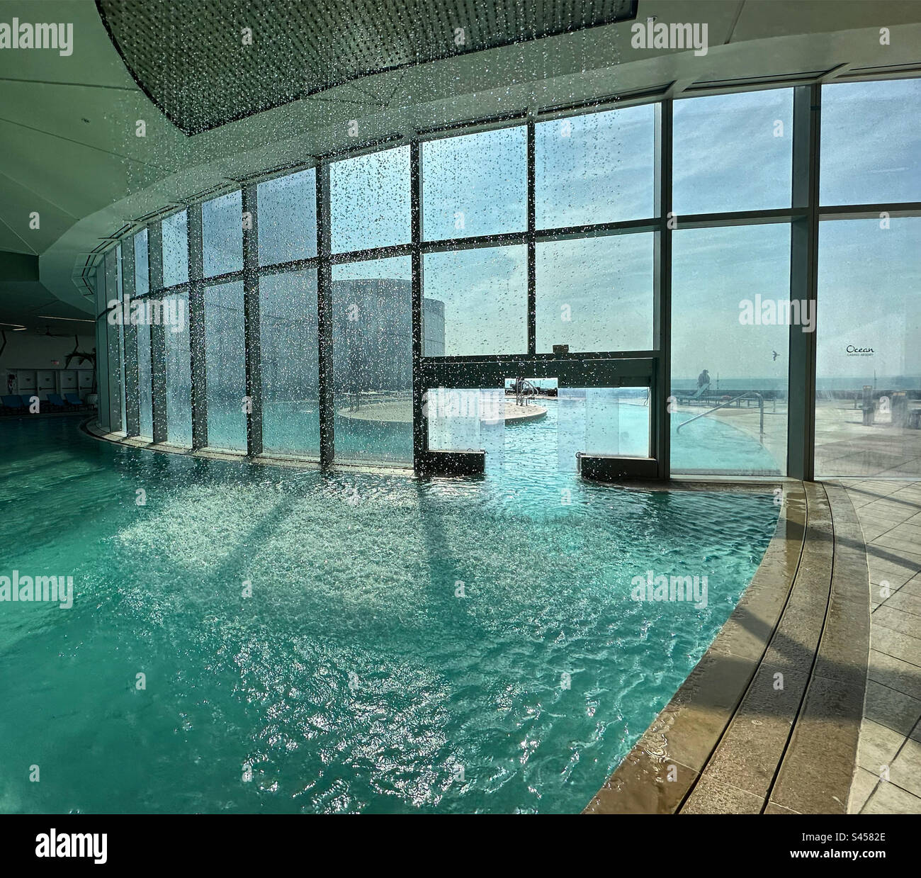 The Eclipse indoor-outdoor pool during a “rainfall,” Ocean Casino Resort, Atlantic City, New Jersey, United States - Smartphone Captured Stock Image