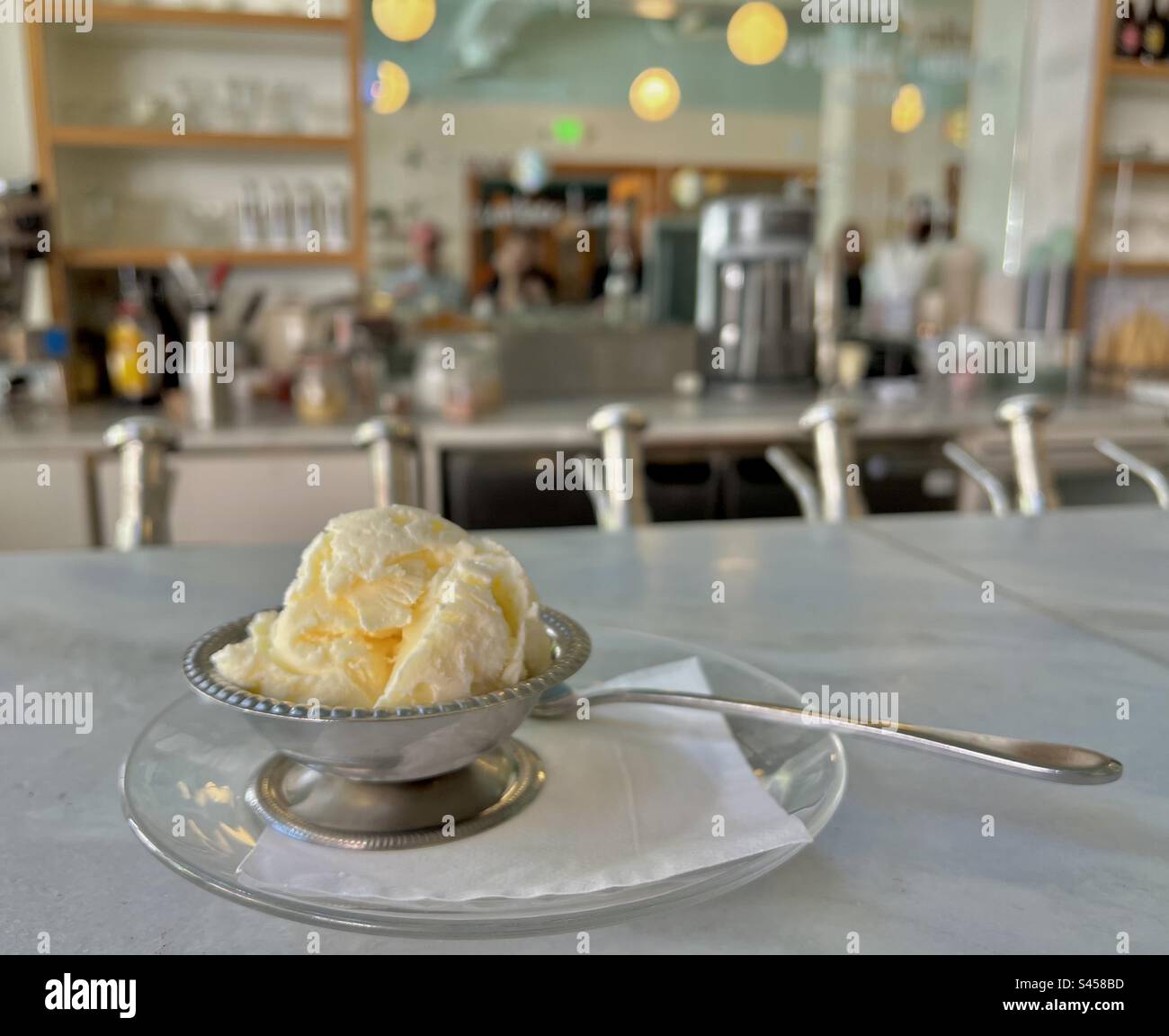 Fresh scooped ice cream in metal dish at an old style ice cream shop in downtown Seattle on a warm summer afternoon. - Smartphone Captured Stock Image