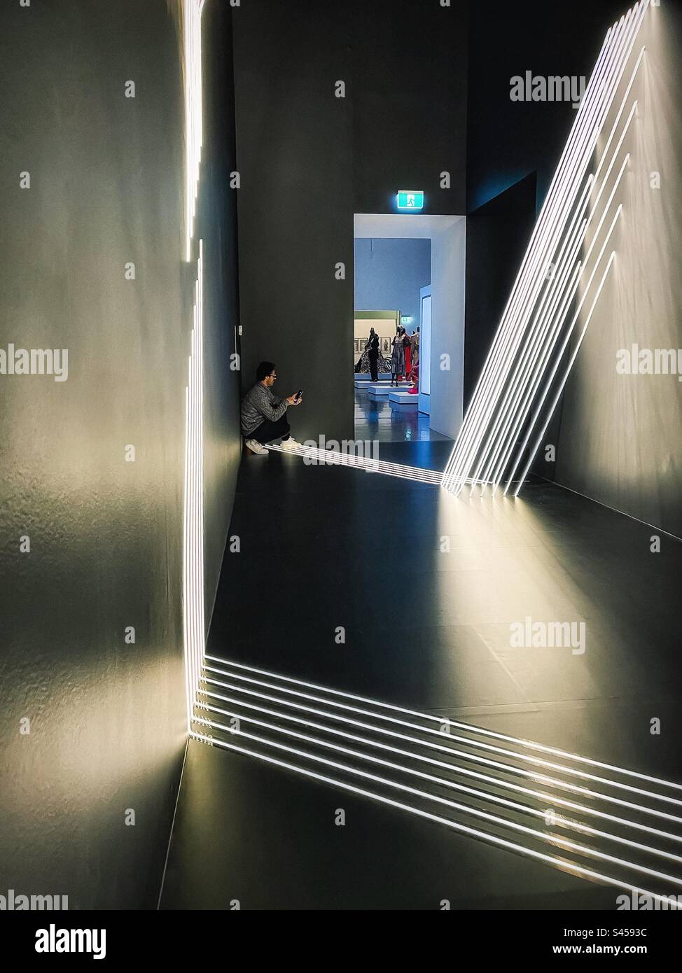 A man using mobile phone to take photos inside light tape installation, Sky Whispers by Meagan Streader at Melbourne Now art exhibition at Ian Potter Centre: NGV Australia, Melbourne, 2023. - Smartphone Captured Stock Image