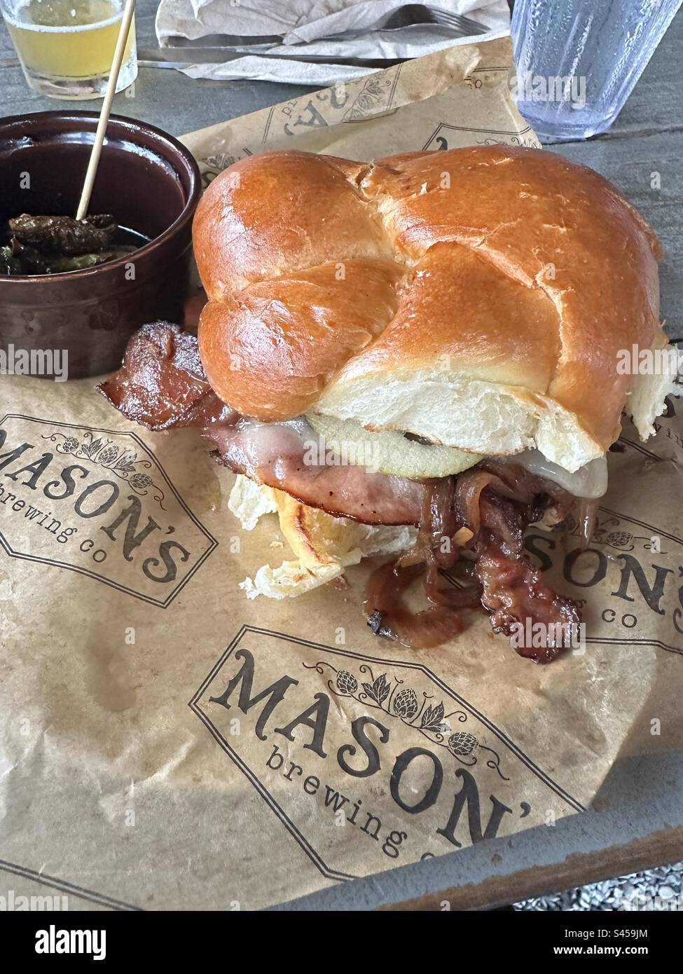 Masons Brewery sweet mess burger chalet roll beef burger, candy bacon, caramelizada onion and thinly sliced apples - Smartphone Captured Stock Image