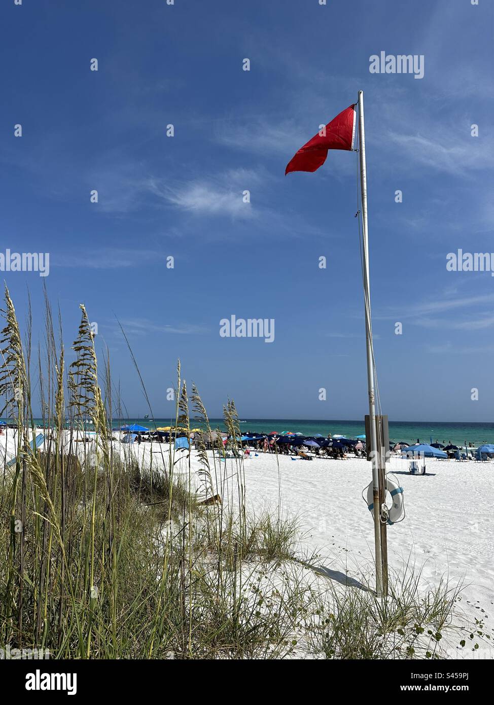 Emerald Coast Florida red flag flying for caution of rip tides June 2023 - Smartphone Captured Stock Image