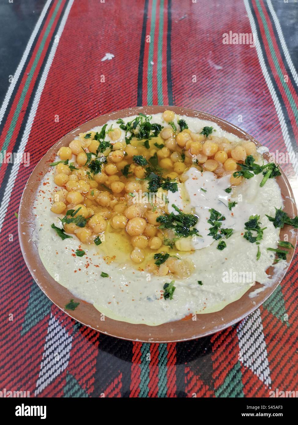 A bowl of Palestinian Hummus. - Smartphone Captured Stock Image