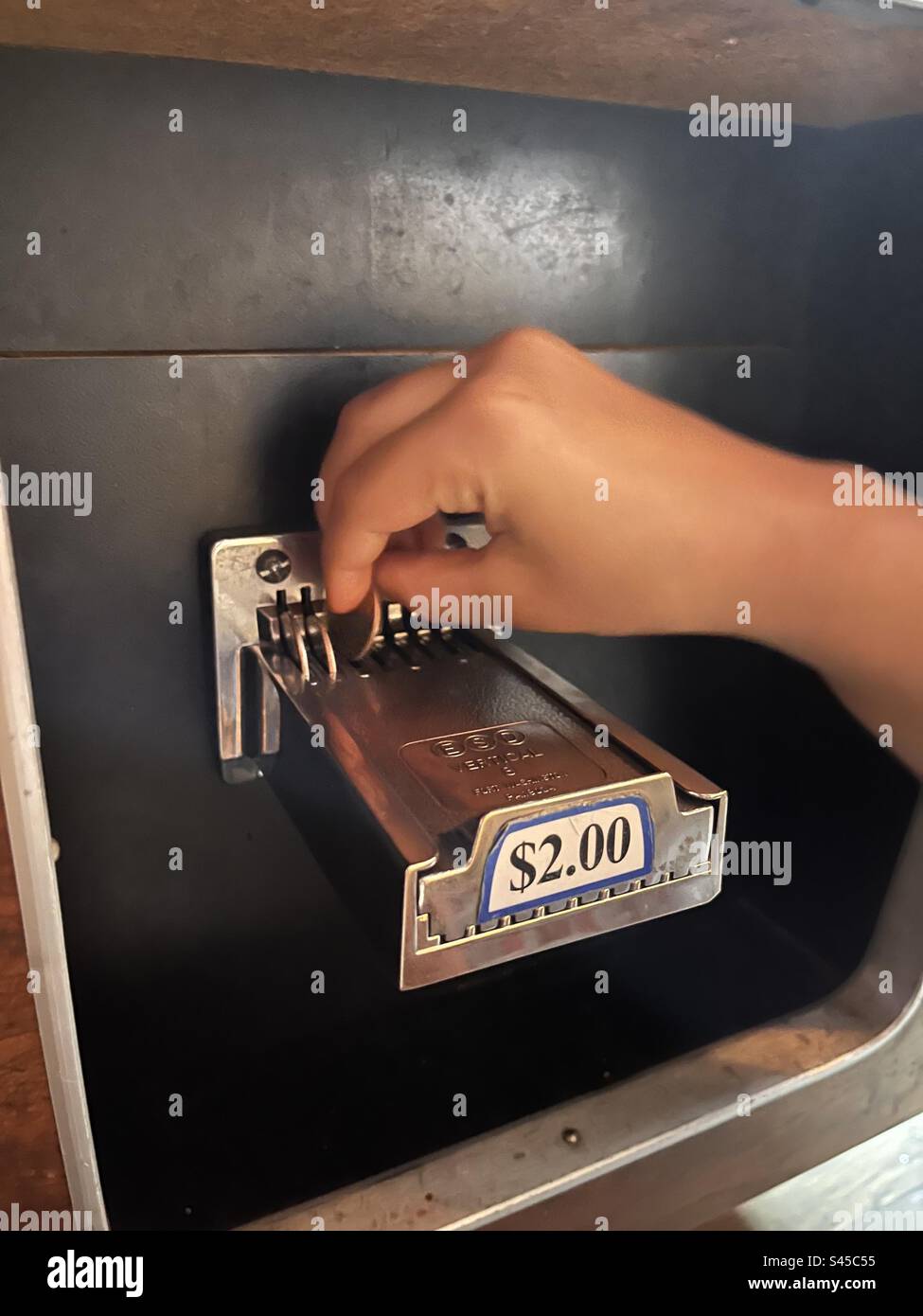 Putting quarters in the pool table - Smartphone Captured Stock Image