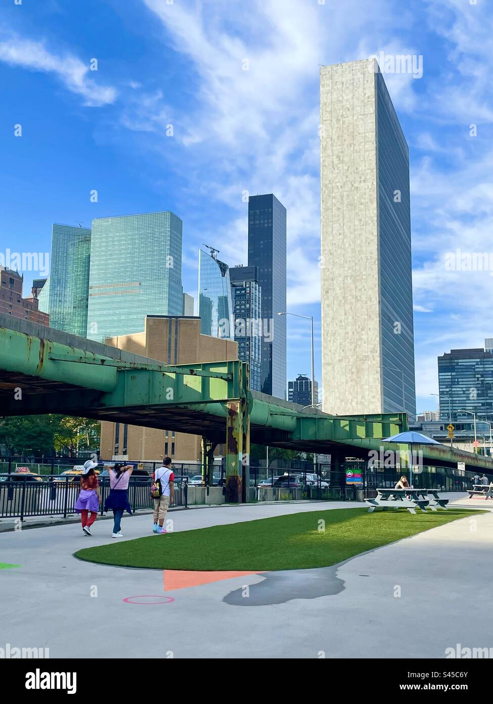 View of the UN from the east river, promenade in New York City - Smartphone Captured Stock Image