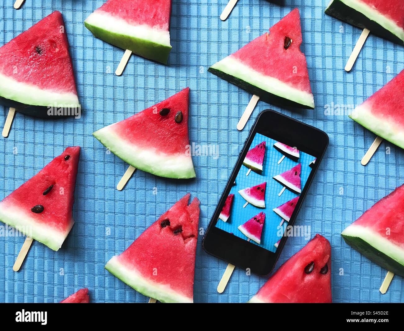 Watermelon triangles on blue background - Smartphone Captured Stock Image