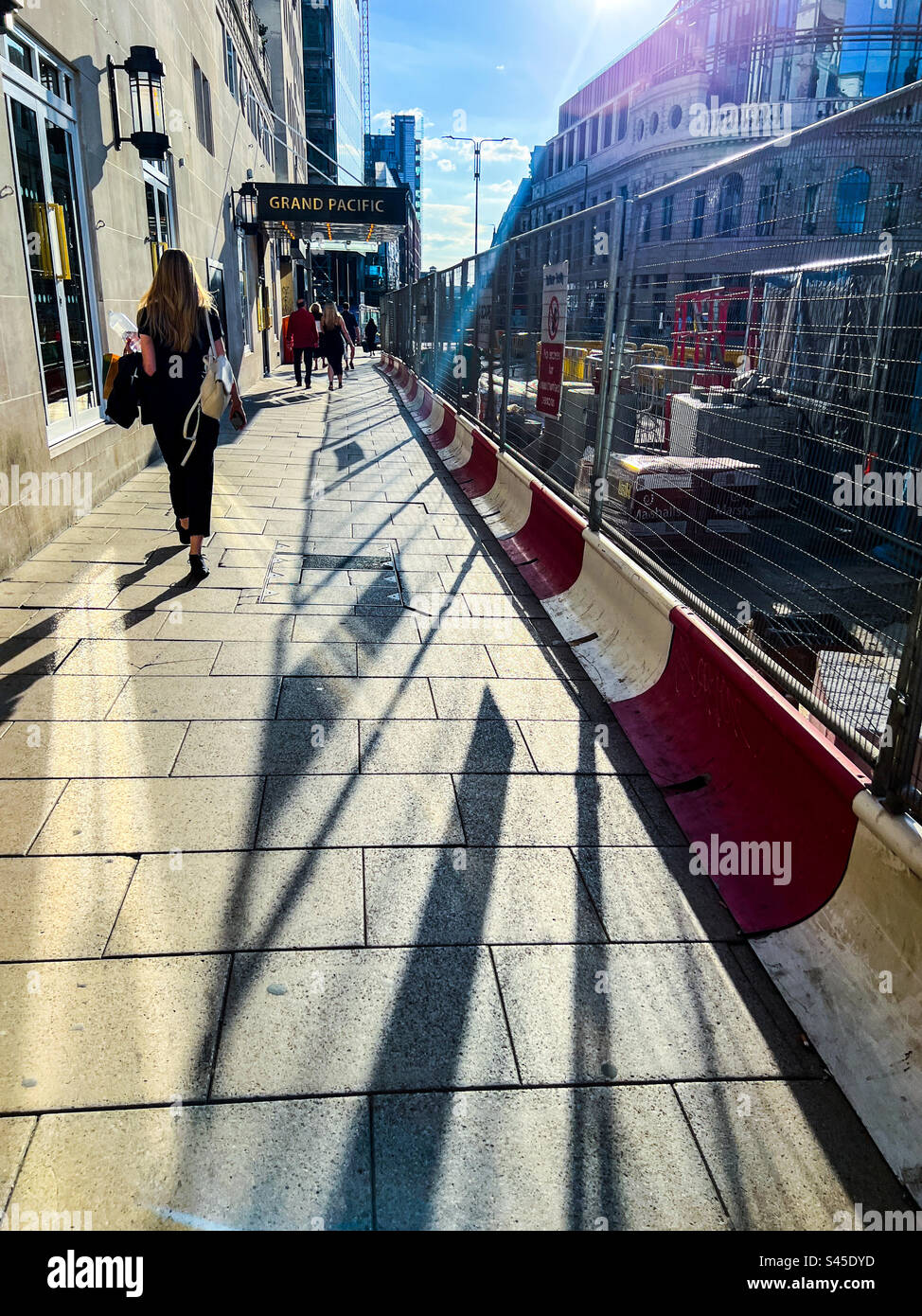 Walking down Wellington Street in Leeds City Centre during midday sun - Smartphone Captured Stock Image